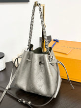 Load image into Gallery viewer, LOUIS VUITTON 2023 Bella Mahina Leather Bucket Bag in Gray Metallic