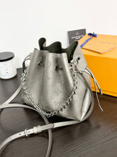 Load image into Gallery viewer, LOUIS VUITTON 2023 Bella Mahina Leather Bucket Bag in Gray Metallic
